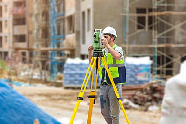 pngtree-construction-topography-worker-on-the-building-site-worker-helmet-surveyor-equipment-city-photo-image_34989834